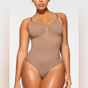 SKIMS SEAMLESS SCULPT BRIEF BODYSUIT IN SIENNA